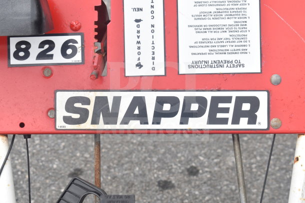 Snapper 8262 Snow Thrower with visible brand and model labels, showing usage wear on red body, ideal for winter tasks.