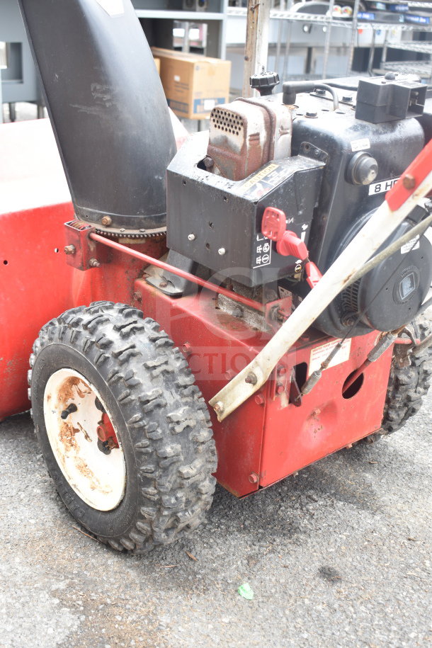 Snapper 8262 Snow Thrower, red and black, visible wear, 8 HP engine, sturdy tires, caution markings on the engine casing.