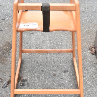 Wooden high chair with natural finish, safety strap, and visible warning label. Good condition with minor wear.