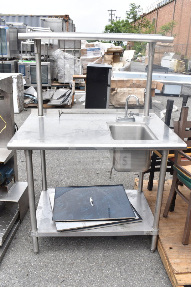 Stainless steel commercial table with sink bay, over shelf, and under shelf; durable and ideal for kitchen use.