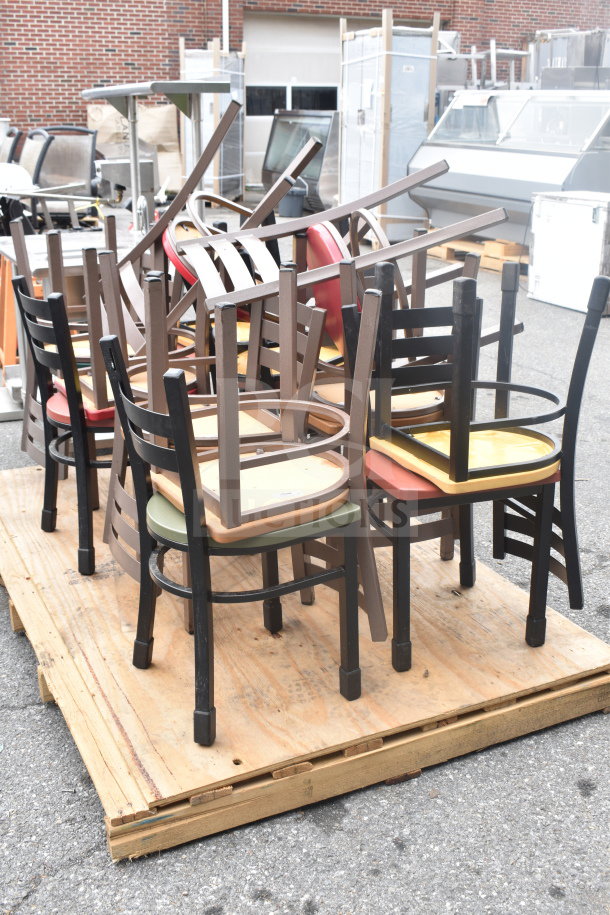18 various dining height chairs with colorful seats on a pallet, mixed wood finishes, good used condition.