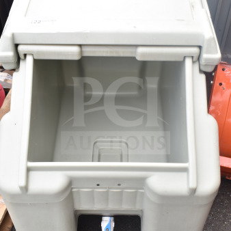 Poly portable ice bin on commercial casters, no lid. Features drainage spout. Light wear, good condition for auctions.