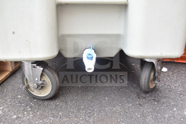 Poly portable ice bin on commercial casters, no lid, visible drainage valve, sturdy wheels, moderate wear.
