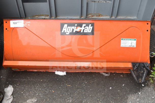 Agri-Fab lawn mower brushing attachment, orange, with brand logo visible. Includes setting brush height instructions. Good condition.