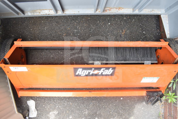 Agri-Fab lawn mower brushing attachment, orange, with visible brand logo, in good condition.