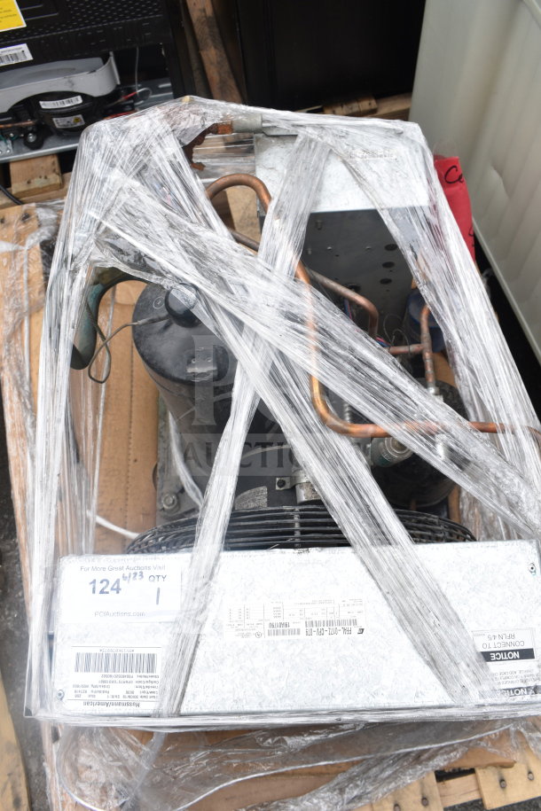 Copeland FFAL-017Z-CFV-079 compressor, 208-230V, 1 phase, wrapped in plastic with visible tags on a pallet.