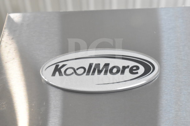 Oval KoolMore logo on the 2025 KoolMore RIR-3D-SS Commercial Refrigerator. Scratches visible.