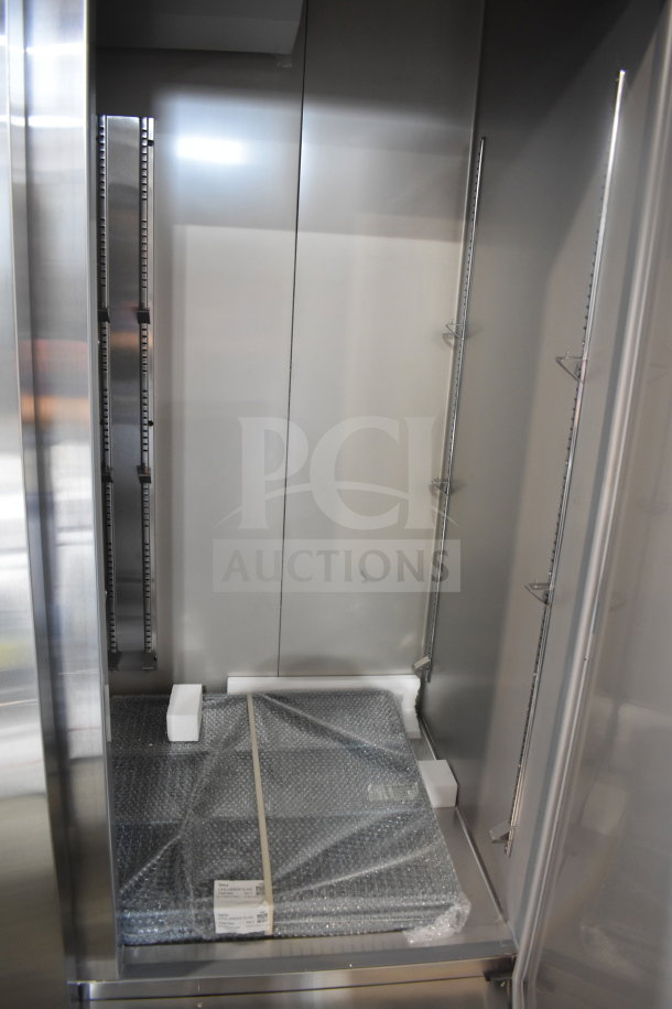 Brand new KoolMore RIR-3D-SS 72 cu. ft. commercial refrigerator interior, tags visible, scratch and dent condition.