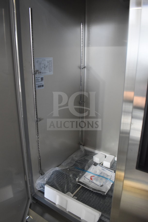 Brand new KoolMore RIR-3D-SS commercial refrigerator interior; shows shelving supports, packaging, and model label.