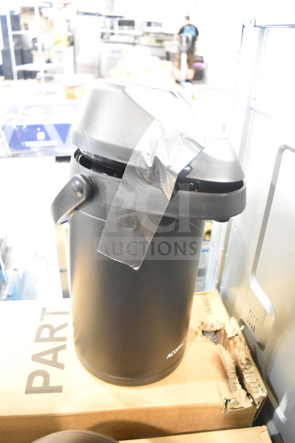 Brand new black air pot with minor scratches and taped lid. Acorn logo visible. Auction includes three units.