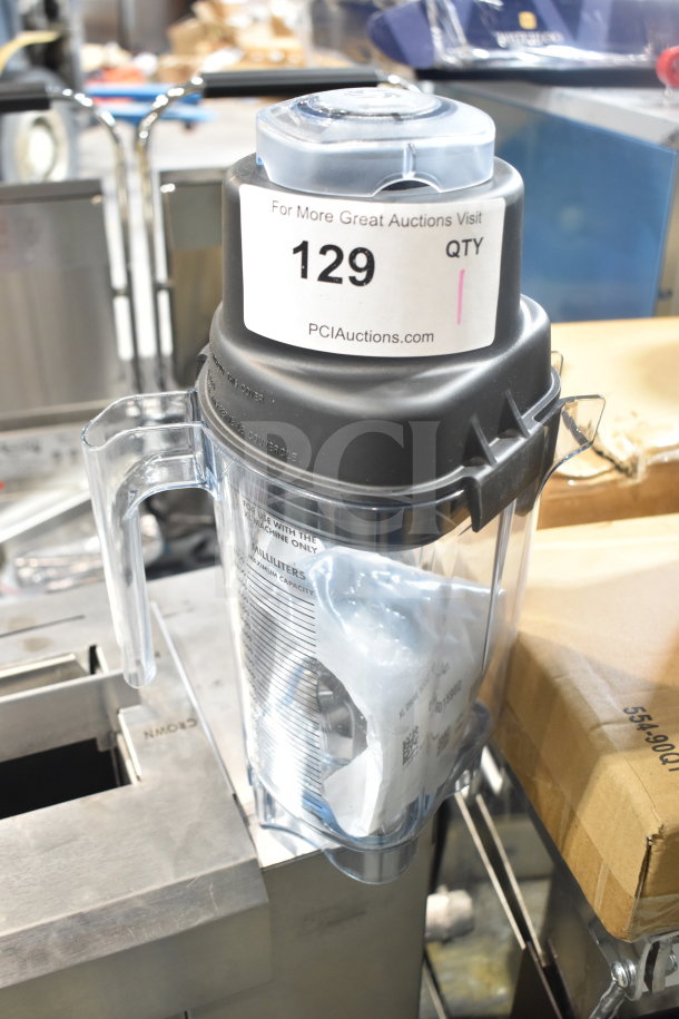 Brand new Blendtec pitcher with minor scratches, clear plastic, secure black lid, model details visible. Tags indicate sale.
