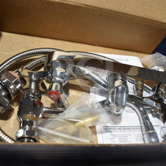 BRAND NEW SCRATCH AND DENT T&S B-1157 wall mounted faucet with spray valve, 8" centers, 8" swing nozzle in box.