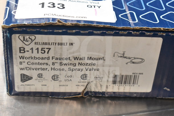 Brand new T&S B-1157 wall-mounted faucet with 8" centers, swing nozzle, spray valve, and minor box wear.