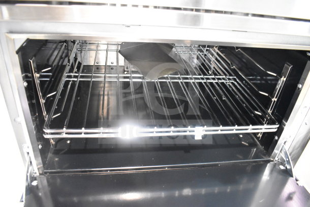 Brand new Vulcan 36C-6BP 6 burner range with convection oven, 36", liquid propane, 215,000 BTU, interior view.