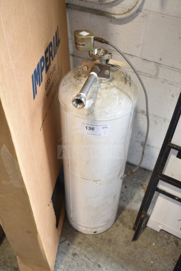 Fire suppression tank with valve and hose, labeled "136." Slight wear on the exterior. Comes with actuator connection.