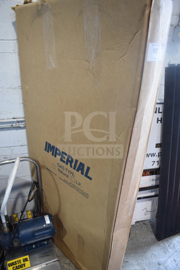 Cardboard box labeled "Imperial" containing a brand new shelf with minor scratches and dents. Box in good condition.