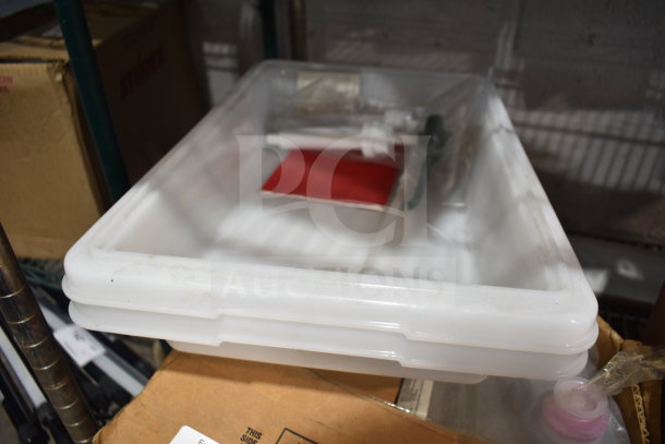 Auction lot with various items including white plastic drop-in bins and a bottle of alcohol foam instant hand sanitizer.