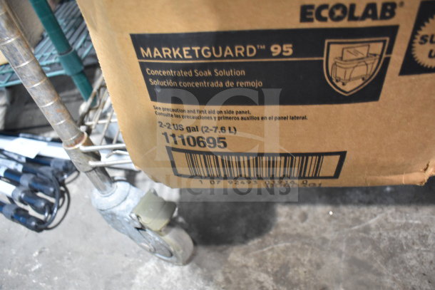 Cardboard box labeled "Ecolab Marketguard 95 Concentrated Soak Solution," with "2-2 US gal" capacity marking. Box on metal cart.