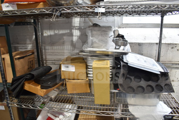 Tiered shelf with assorted items including drop-in bins, pan liners, and cardboard boxes. Visible tag marked "139".