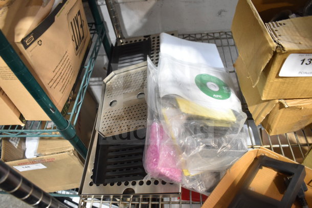 Auction lot with drop-in bins, pan liners, CD labeled "APC", and various boxed items on metal shelving.