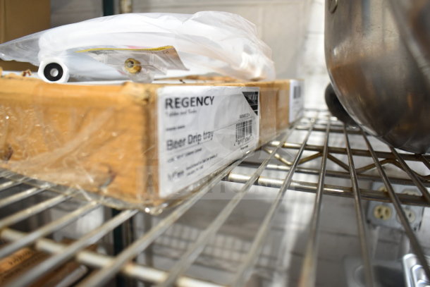 Alt text: Box labeled "Regency Beer Drip Tray 600MBDCCB14" on shelf, with gas hose. Flipped bids apply to four items.