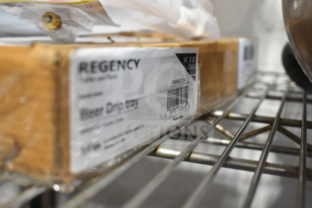 Box containing a Regency beer drip tray, model 600MBDCCB14, on a metal shelf. Packaging shows product details and barcode.