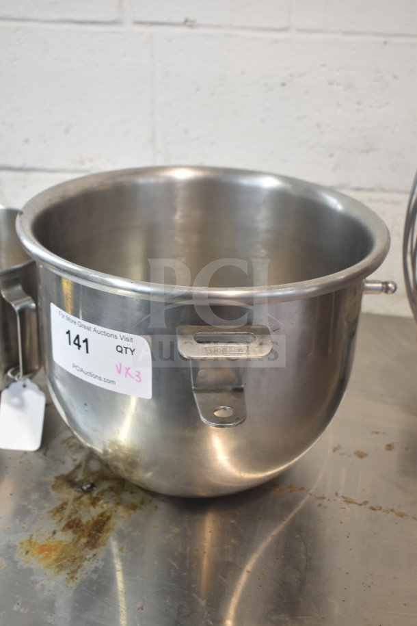 Stainless steel mixing bowl with Hobart handle, includes auction label. Part of a 3-item mixer set with whisk.