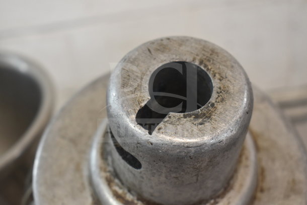 Close-up of a mixer component, showing wear. Two mixing bowls and a whisk attachment included in the auction lot.