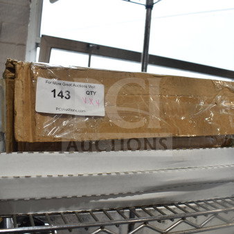 Cardboard box with label "143 QTY XX4," contains various items including Lavex 17" green scrubbing pads and Norton Q421 floor screen discs.