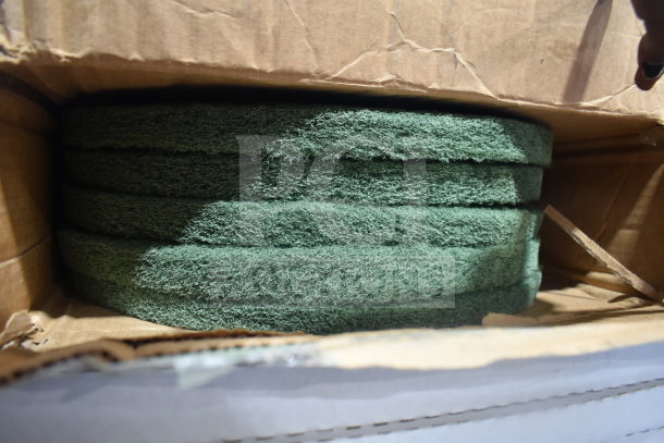 Box of Lavex 598AVG17GN 17" green scrubbing pads. Visible are stacked pads in good condition, ideal for floor maintenance.