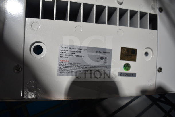 Interior view of Canopy Light with label showing model CP-100W. Rated power 100W, 100-277VAC, CCT 5000K. Made in China.