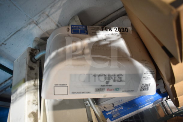 13 various items including a DualLite exit sign and Cooper LED outdoor emergency light. Labels indicate model and maintenance info.