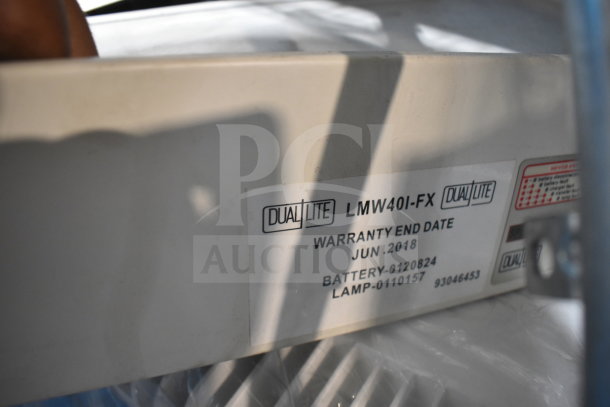 DualLite exit sign, model LMW40I-FX, showing warranty end date June 2018 and battery details, part of auction lot.
