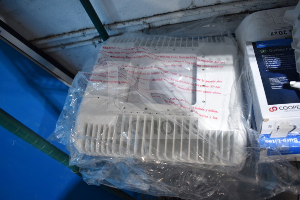 13 assorted items including a DualLite exit sign and Cooper LED outdoor emergency light. New, sealed in packaging.
