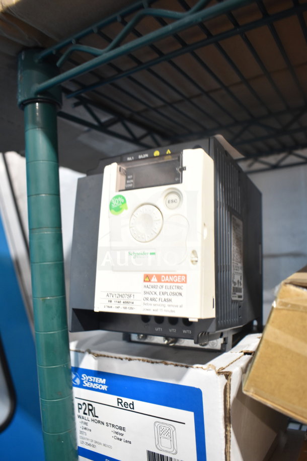 Altivar ATV12H075F1 Variable Speed Drive, new condition, features control dials and warning labels.