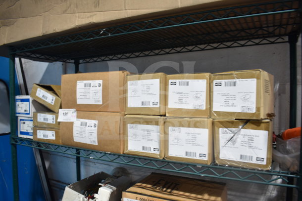 Boxes of 19 various DualLite items, including double remote heads and LED emergency lights. Label details shown.