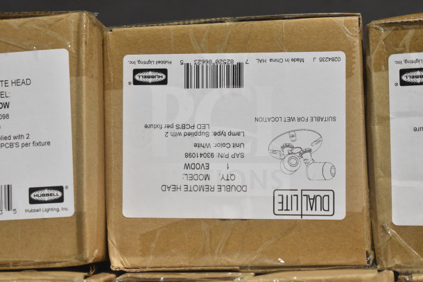 Boxes of DualLite Double Remote Head and LED Emergency Lights with labels, part numbers, and barcodes visible.