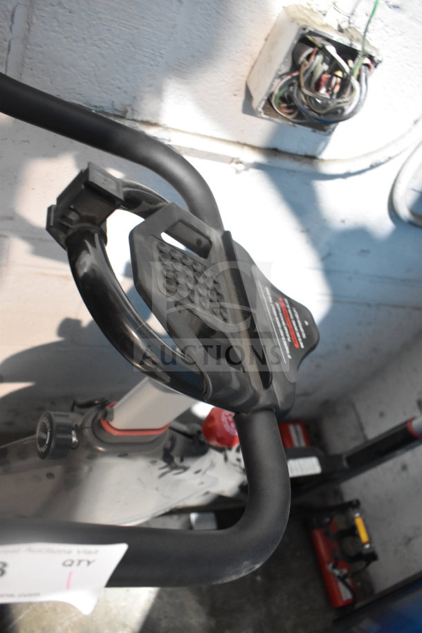 D615 Stationary Exercise Bicycle with black handlebars and pedal system. Shows moderate use. No visible brand markings.