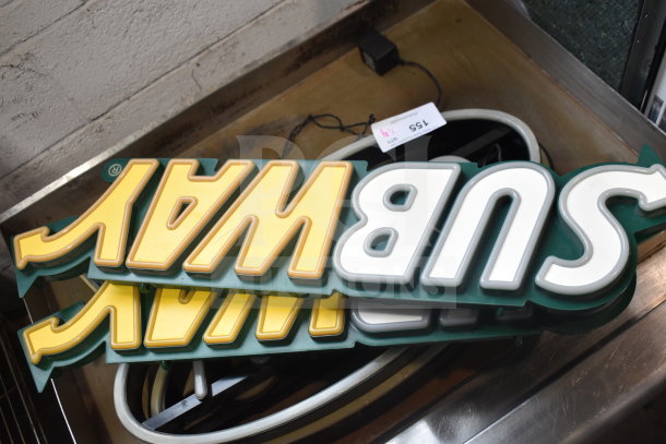 4 Subway signage pieces, yellow and white lettering, stacked. Includes power cord. Auction tag visible.