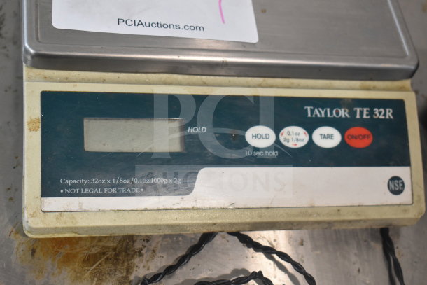 Taylor TE32R countertop scale with capacity of 32oz/1000g, LCD display, and control buttons. Label indicates "not legal for trade."