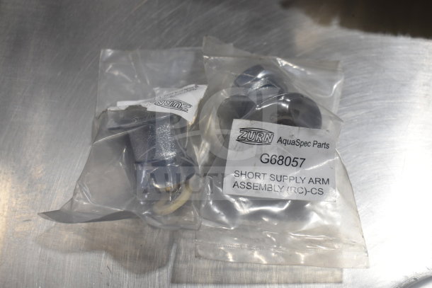 Zurn AquaSpec parts in sealed bags, model G68057. Includes short supply arm assembly, visible labels detail product info.