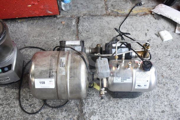 Stainless steel carbonators set, auction lot 158, with visible warning labels and wiring, in used condition.