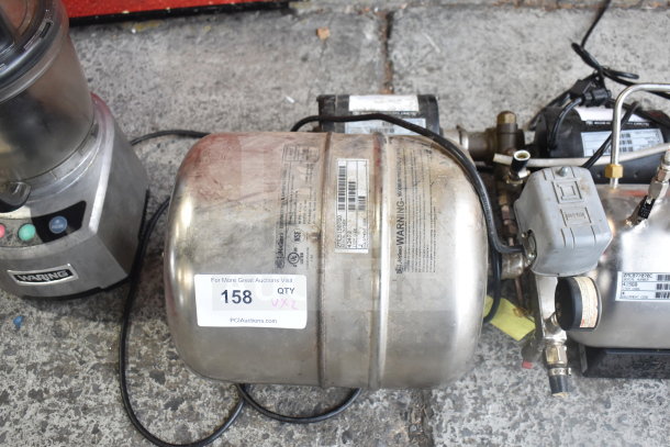 Two stainless steel carbonators with visible wiring and labels. Auction tag "158 QTY VXZ." Used condition.