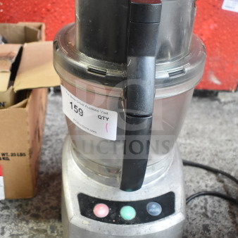 Waring countertop food processor, 115 volts, 1 phase, showing buttons and handling grip. Good condition. Auction tag visible.