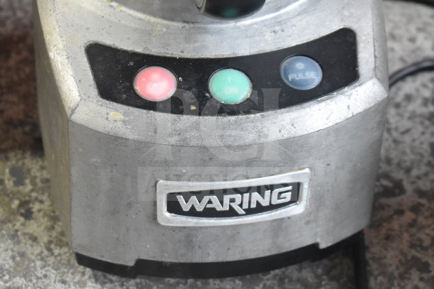Waring countertop food processor with three buttons: red, green, blue. Model shows signs of use. 115 volts, 1 phase.