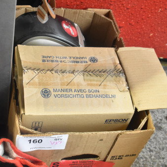 Box containing Dymo label printer and Epson receipt printers, models M129H and M244A, with packaging showing "Handle with Care."
