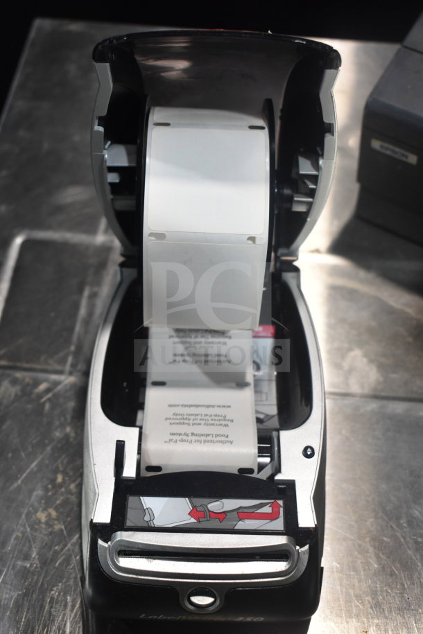 Dymo LabelWriter 450 label printer in open position with label roll visible, in used condition.