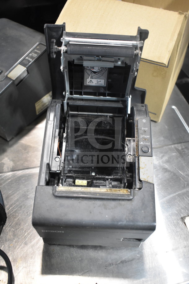 Epson receipt printer with open cover, showing interior. Includes Dymo label printer and Epson M129H. Good condition.