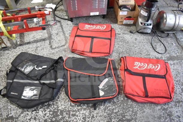 Four hot food catering carrying bags, two red with "Coca-Cola" logo, and two black with reflective stripes, slightly worn condition.
