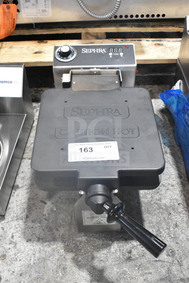 Sephra SERTWFL01 commercial countertop waffle maker, black, 110-120 volts, with temperature control dial and caution label.